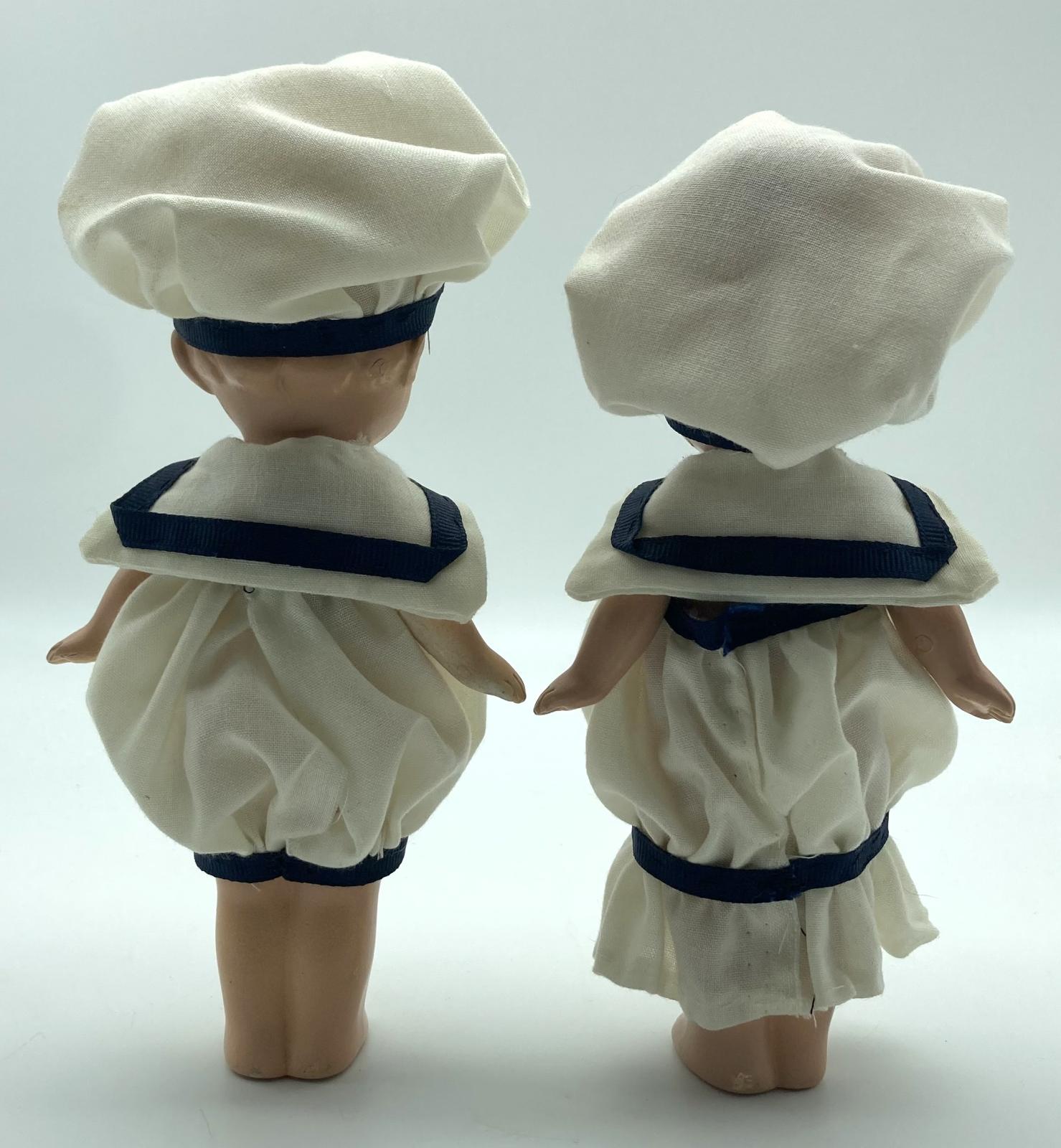 Bisque sailor boy and girl from back