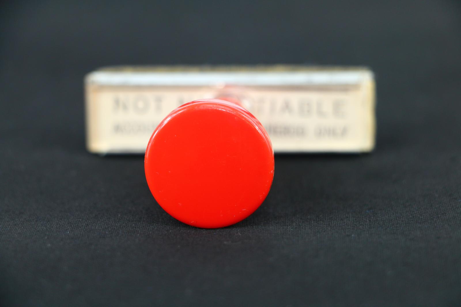 A rectangular rubber, City of Wanneroo Not Negotiable stamp, which has a red plastic handle.