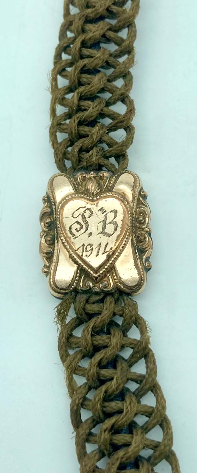 Front of central decoration of mourning Albert chain showing engraved inscription