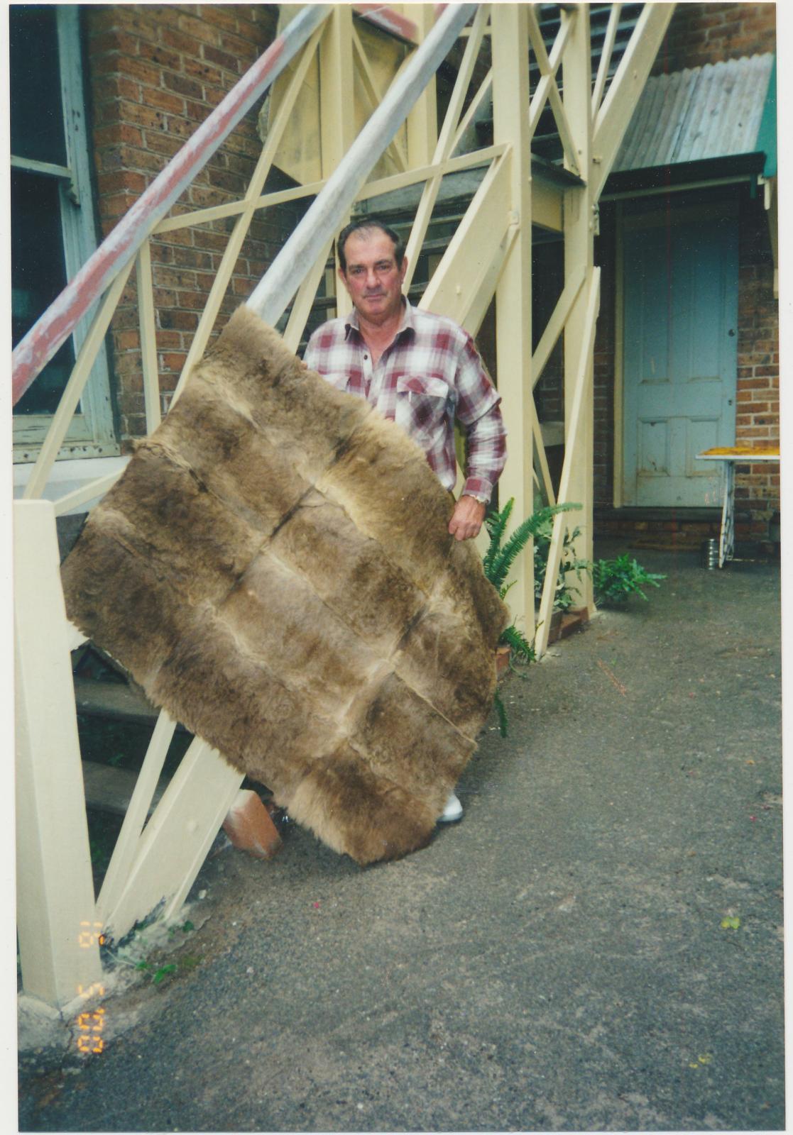 Man holding a Kangaroo Skin Rug