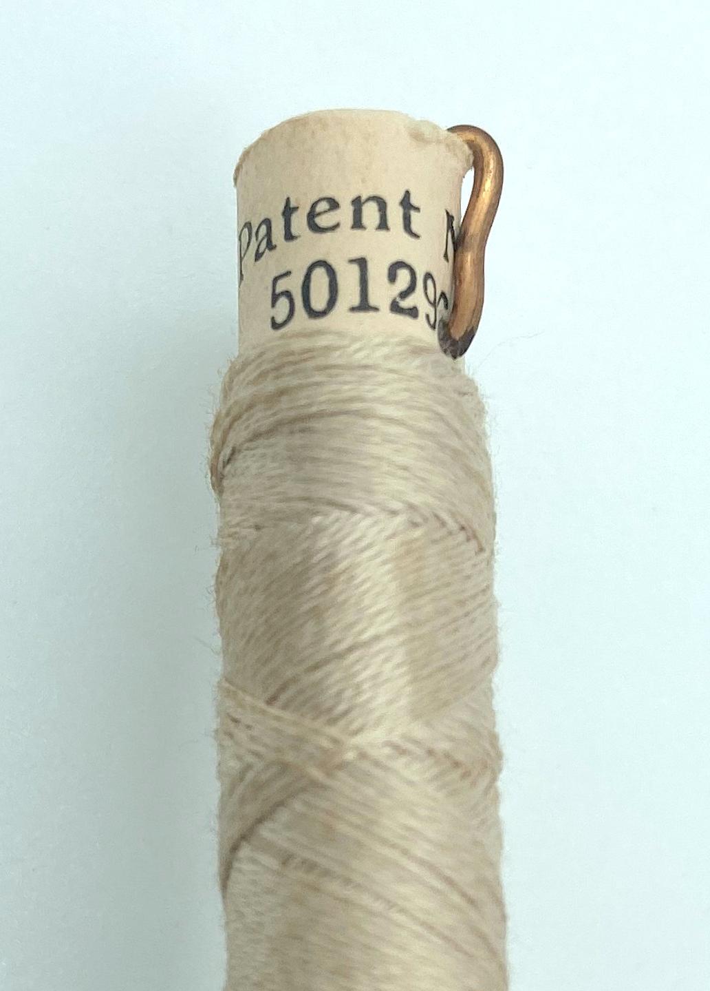 Close up of cotton reel showing patent number