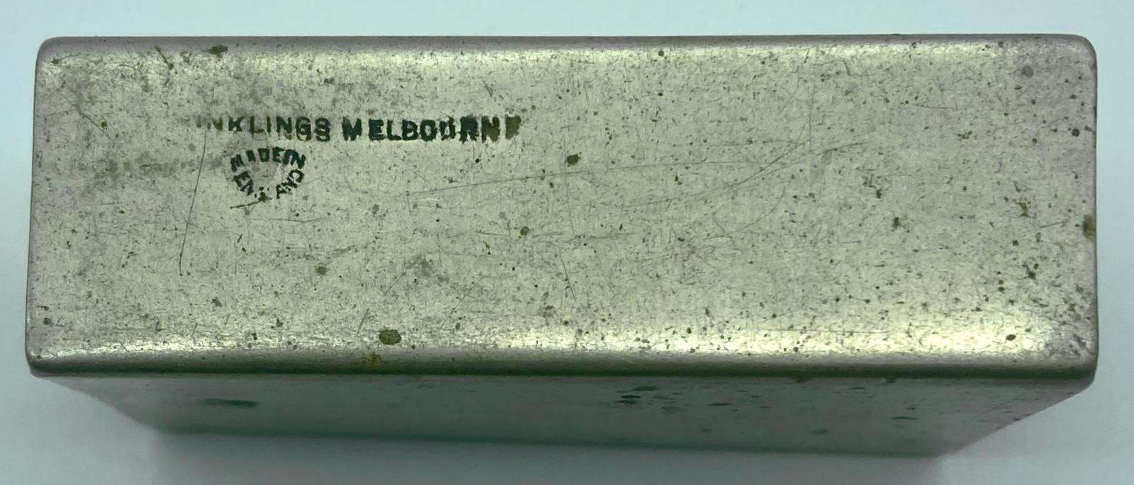 Side view of metal matchbox cover showing maker's details
