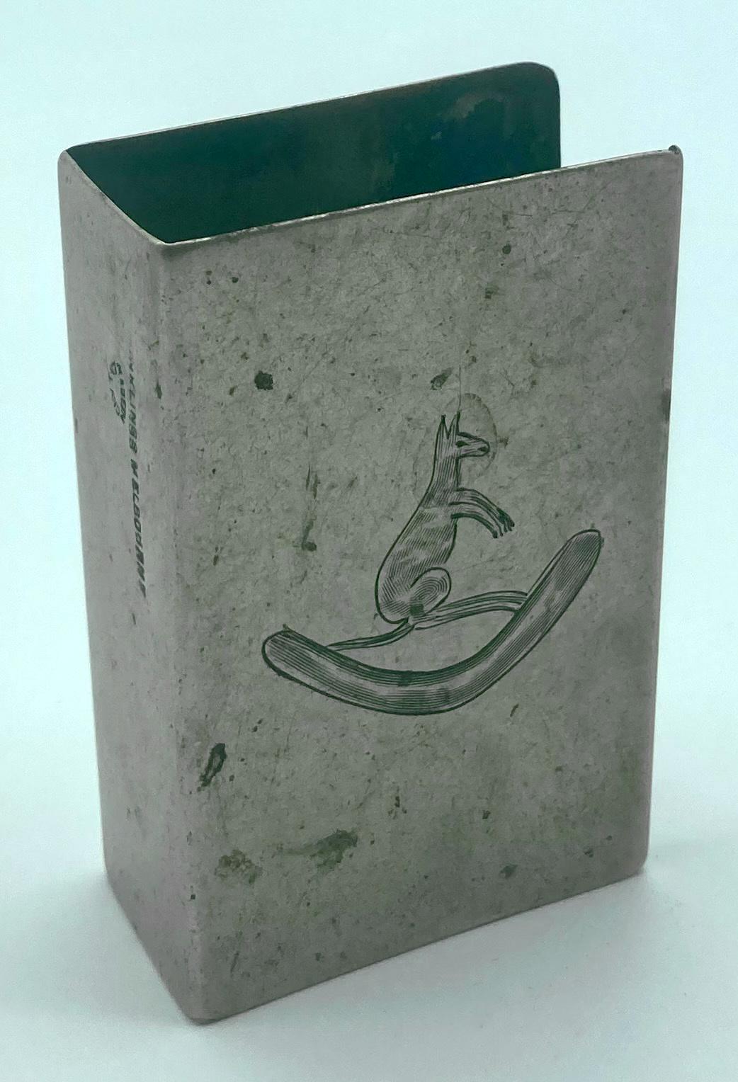 Metal matchbox cover featuring engraving of a kangaroo on a boomerang - oblique view