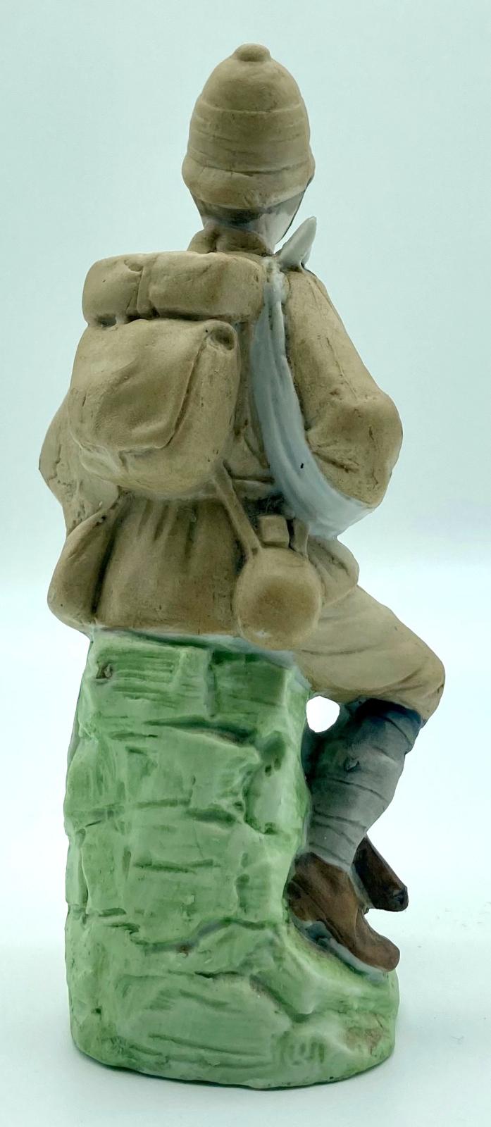 Bisque figurine of a wounded Boer War soldier - back view