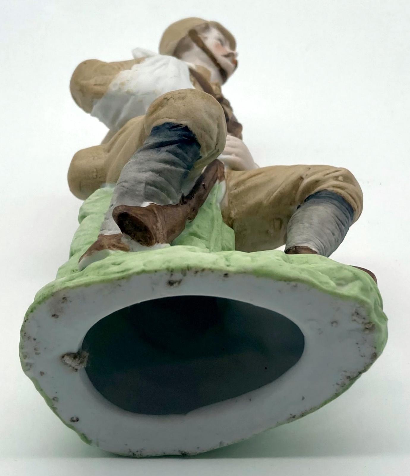 Bisque figurine of a wounded Boer War soldier - view from base