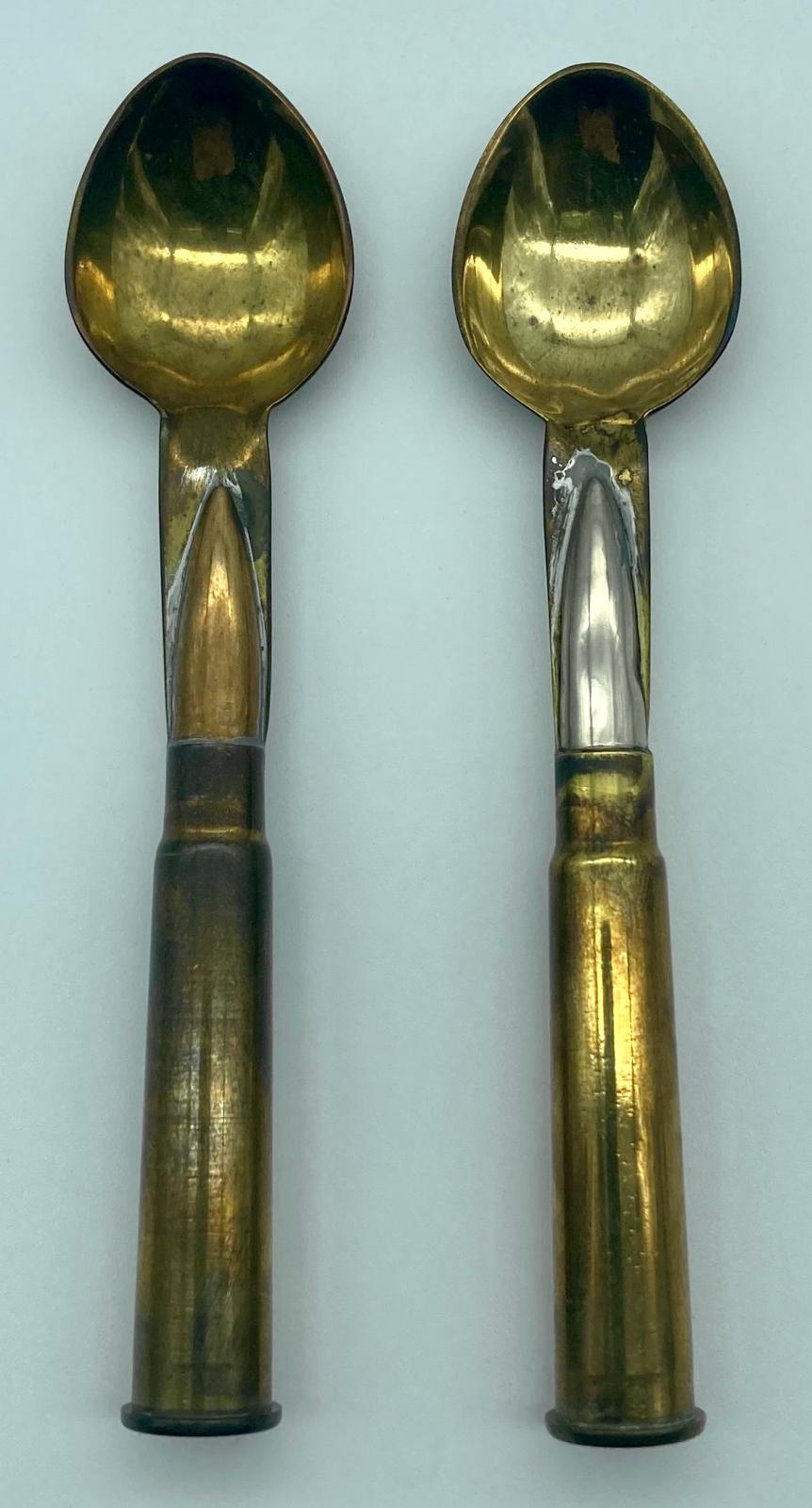Close-up of front of two spoons from trench art cutlery set