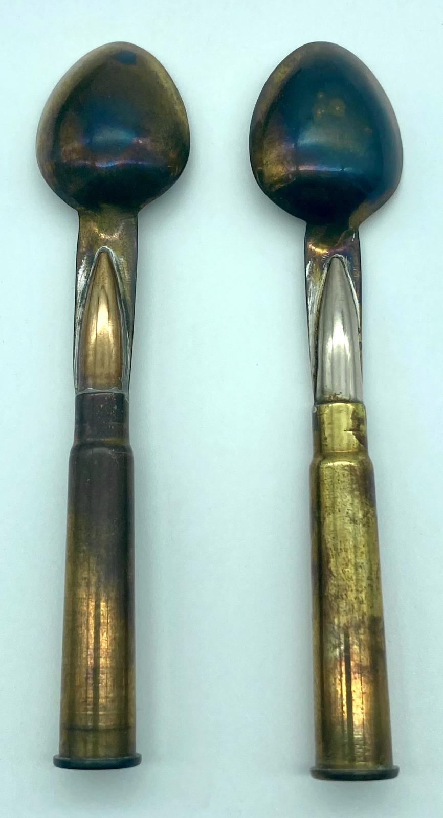 Close-up of back of two spoons from trench art cutlery set