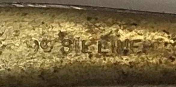 Close-up of markings on reverse of 9ct gold, silver lined brooch featuring a kangaroo on a boomerang