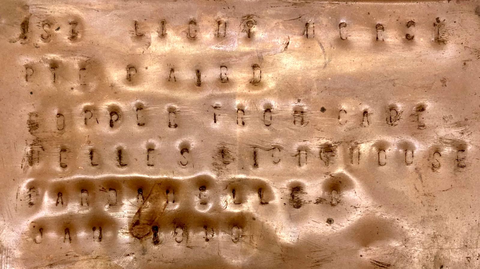 Close up of inscription on copper tray