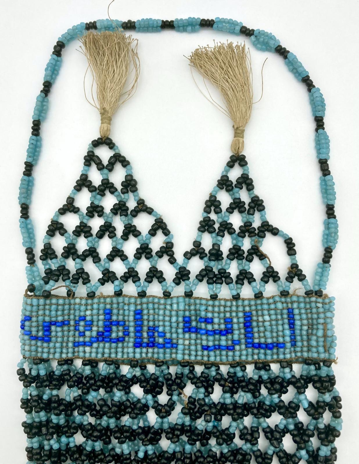 Upper section of reverse of Ottoman prisoner of war beadwork bag with tassels