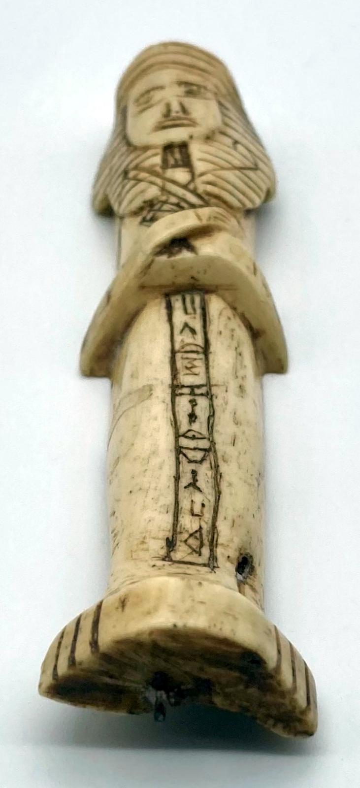 View from base of carved camel bone in the form of an Egyptian shabti