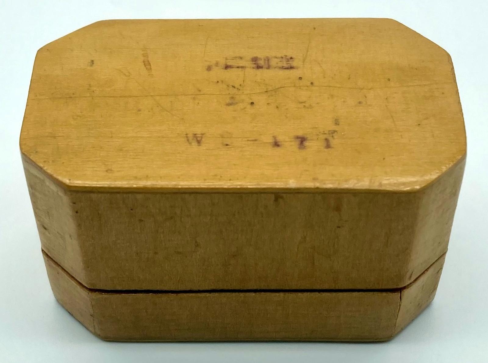 Lacquered timber box with bird motif - side view of underneath