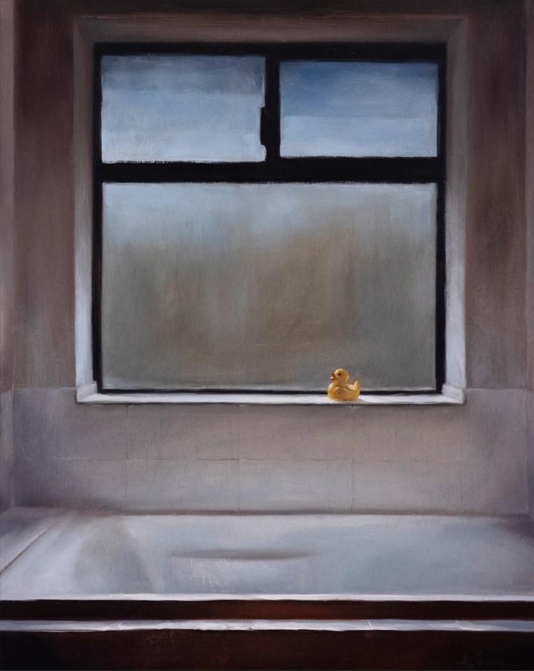 A yellow rubber duck toy on a windowsill in a bathroom