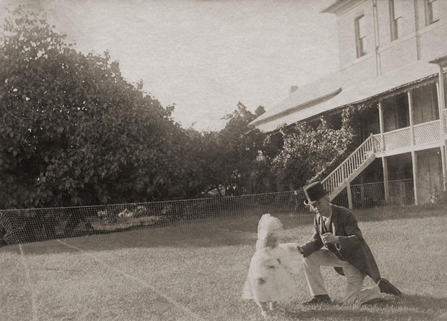Child And Man On A Tennis Court
