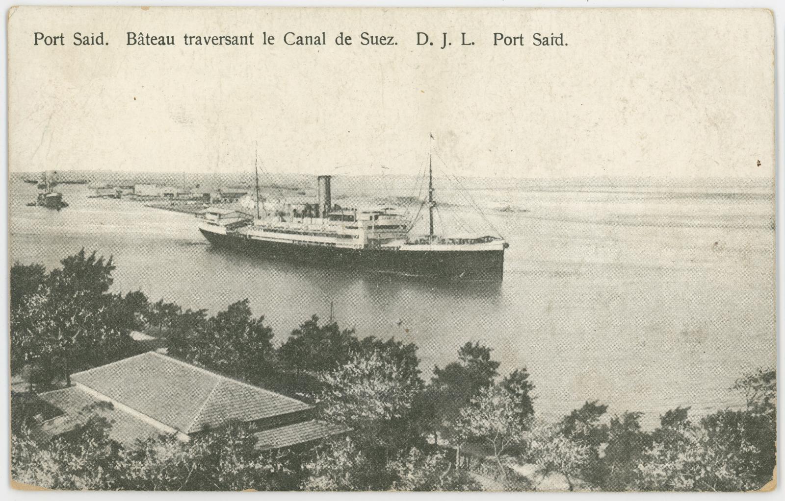 Black & white postcard of “Port Said. Bateau traversant le Canal de Suez. D.J.L. Port Said”, sent by Spr John DENNEY.