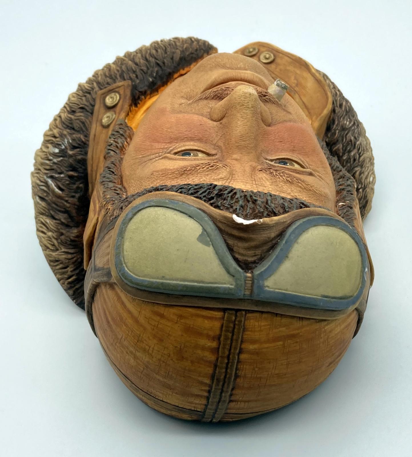View from above of painted chalkware wall hanging depicting Royal Flying Corps pilot 1917
