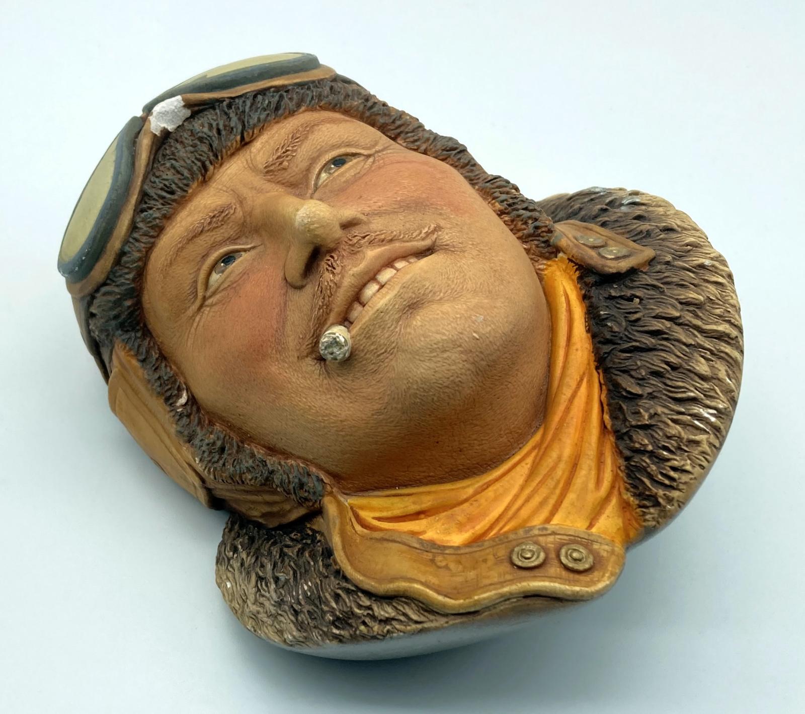 Oblique view of painted chalkware wall hanging depicting Royal Flying Corps pilot 1917