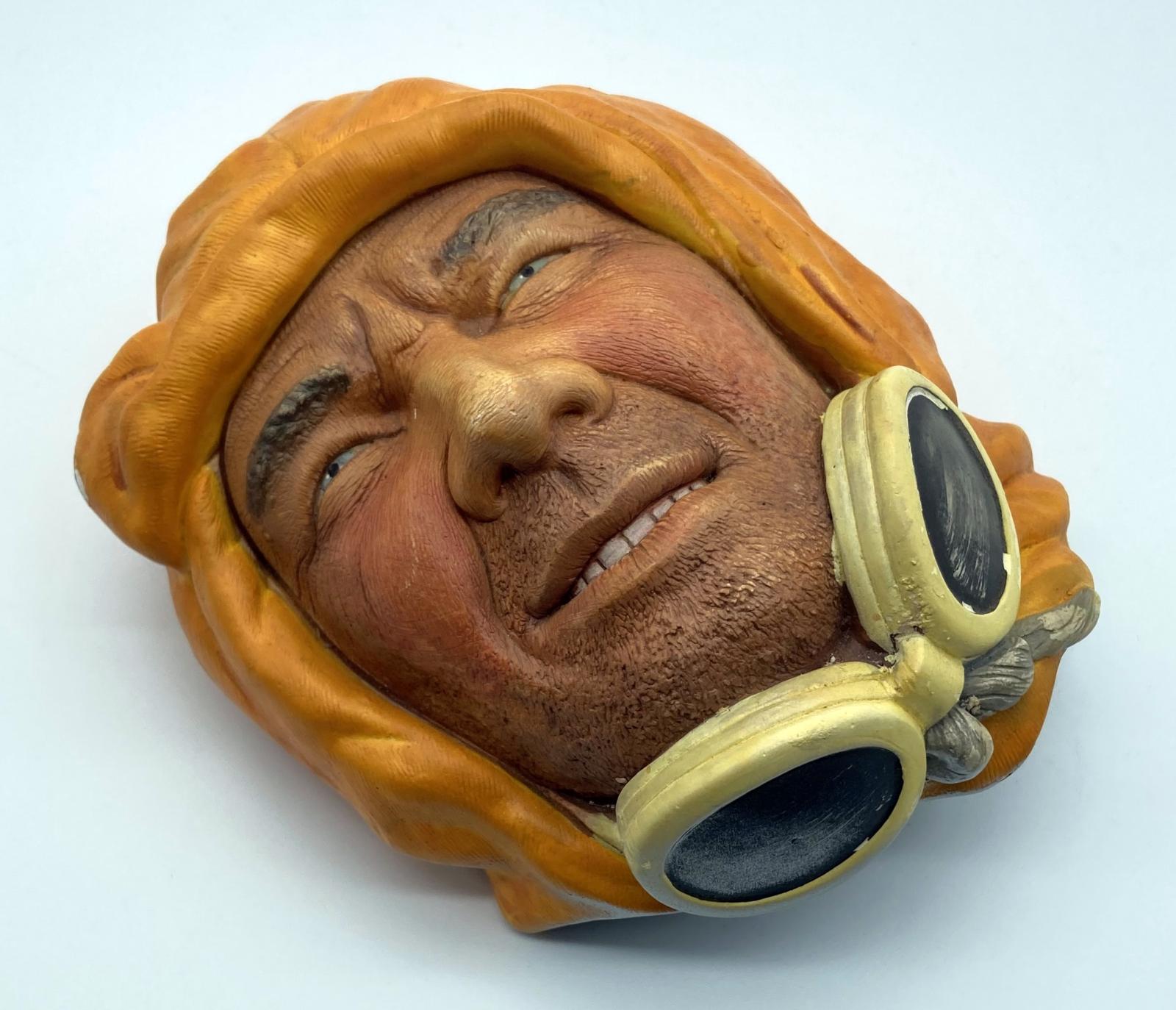 Oblique view of painted chalkware wall hanging depicting an Arctic explorer