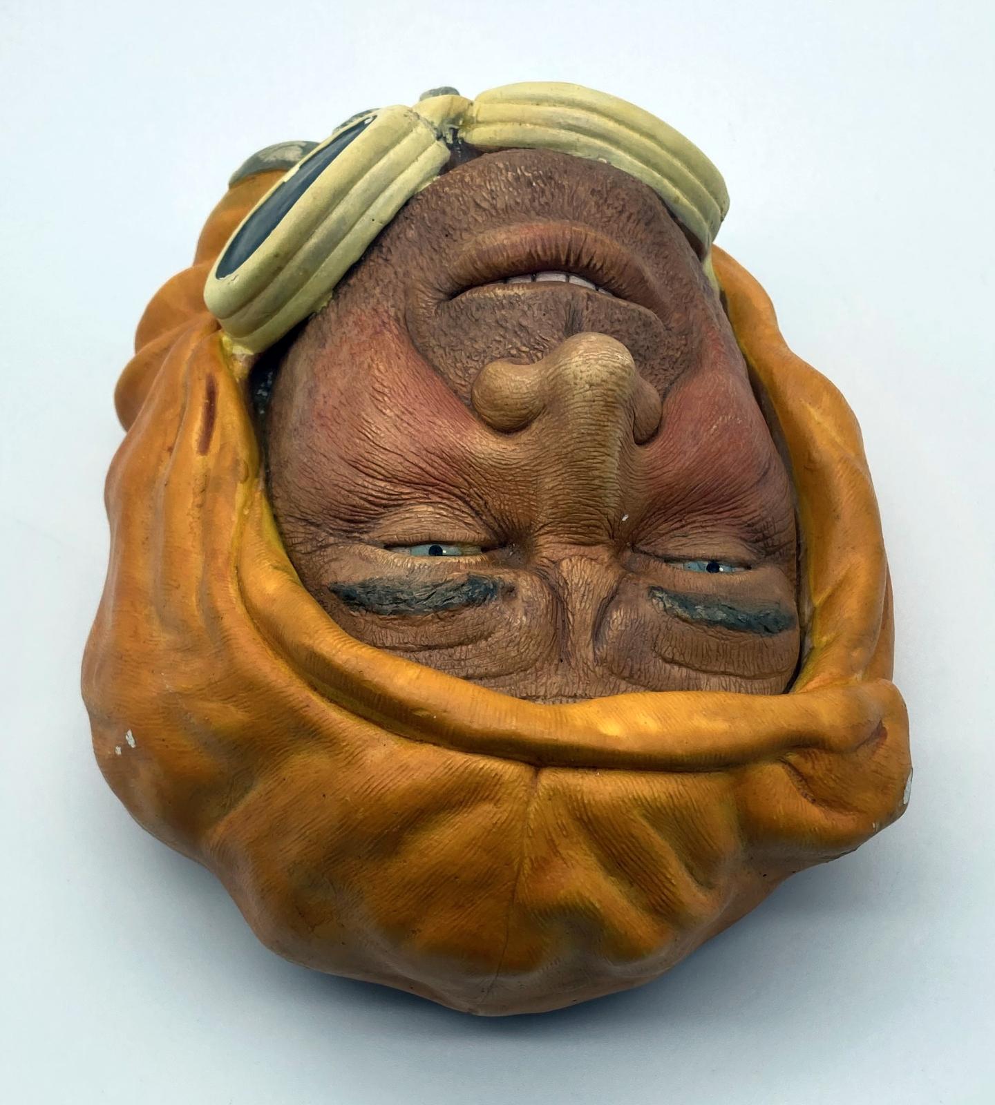 View from above of painted chalkware wall hanging depicting an Arctic explorer