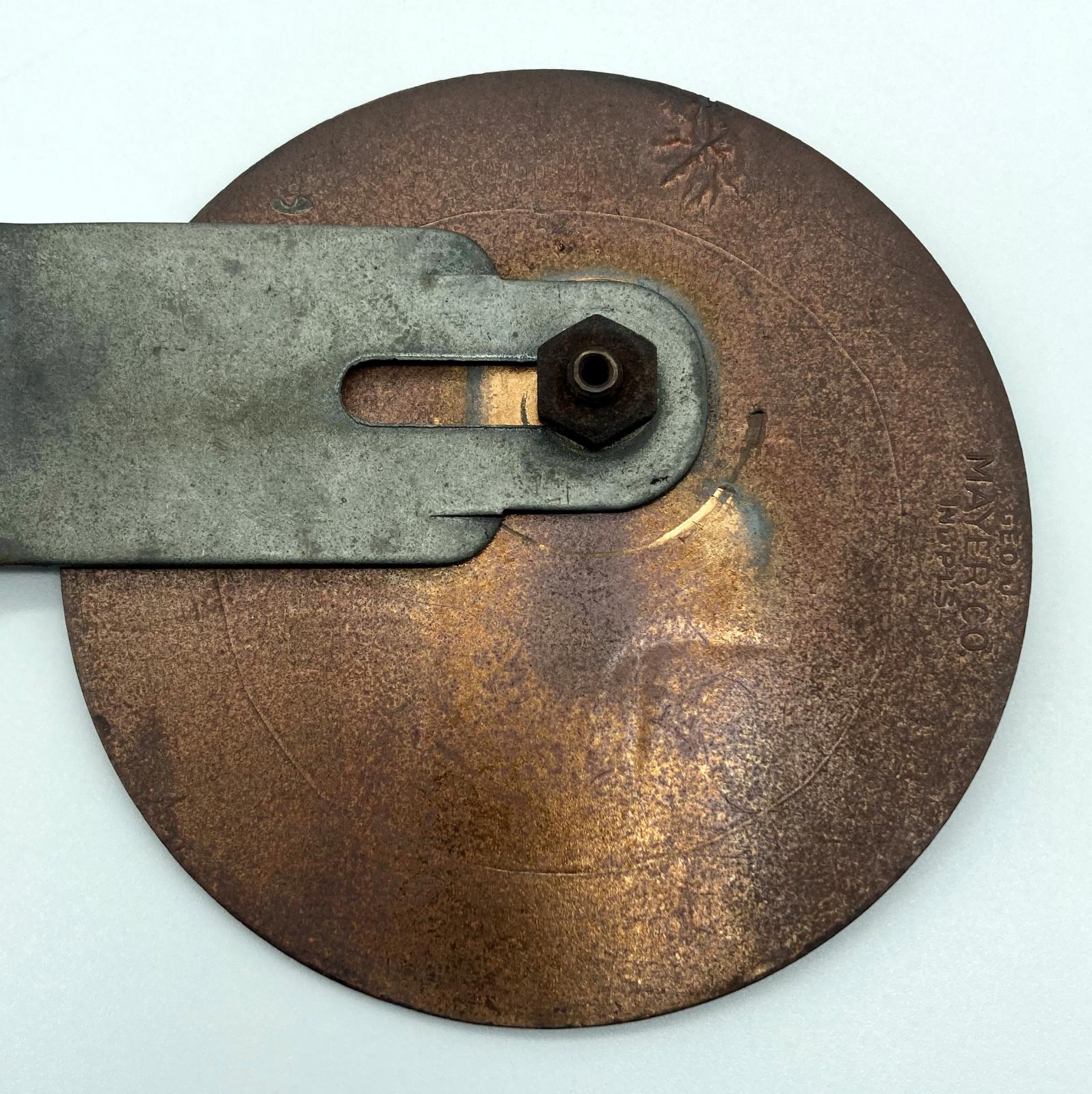 Close up of reverse of WWI era American Red Cross Motor Corps car badge