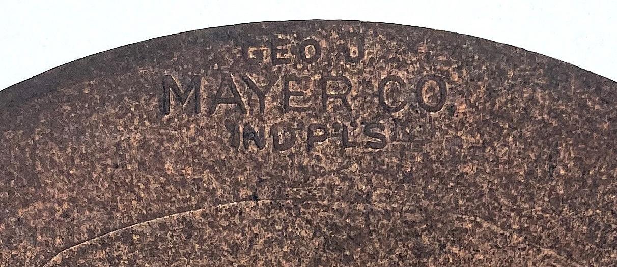 Close up of reverse of car badge showing maker's details