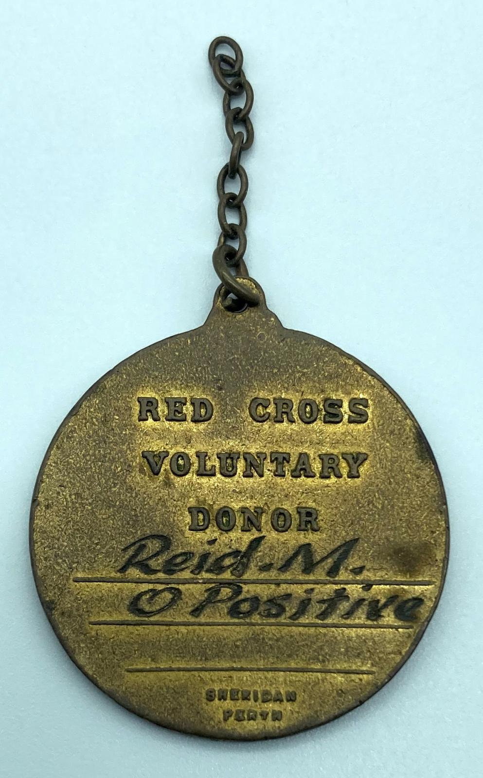Reverse of metal and enamel fob presented to Red Cross Voluntary Donor, M.Reid