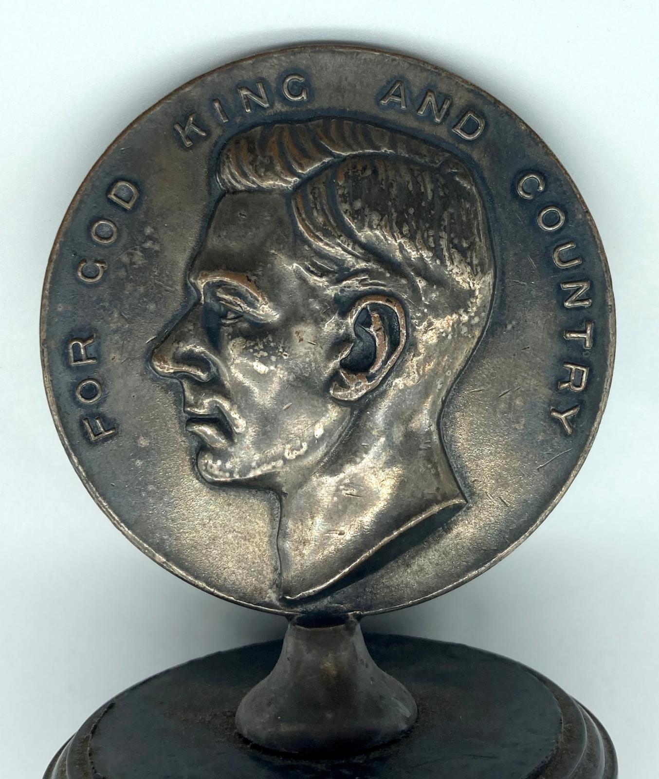 Close up of reverse of medallion showing portrait of King George VI