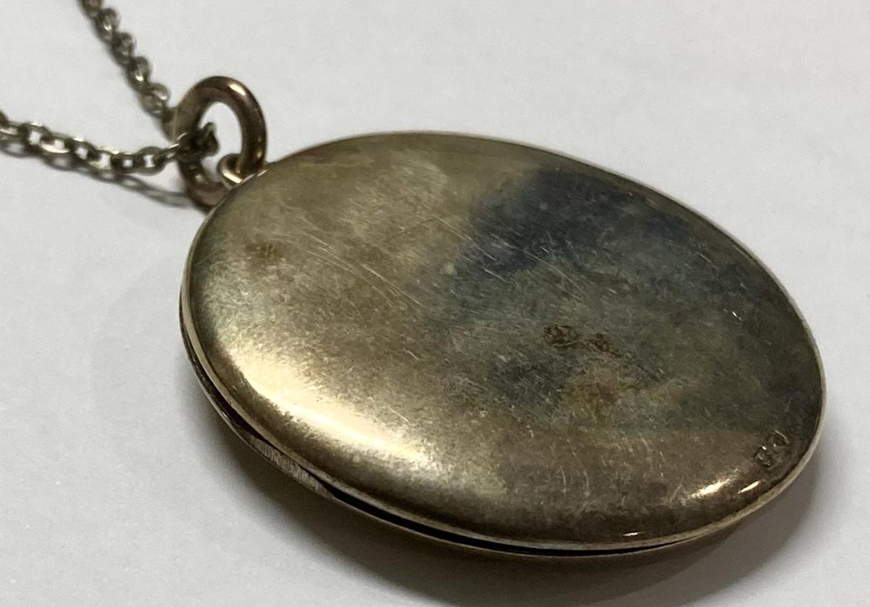 Outside of WWI silver locket - closed bottom side showing silver mark
