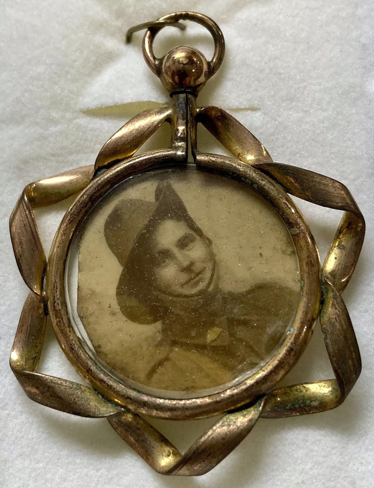 Front of WWI era double-sided pendant locket featuring young soldier