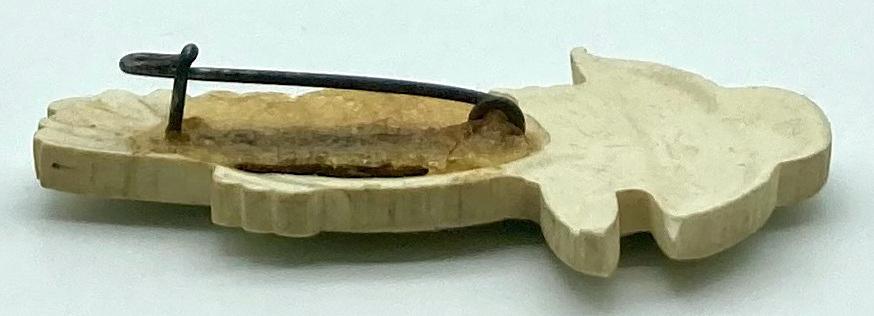 Side view of moulded plastic brooch depicting a kookaburra