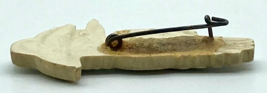 Other side view of moulded plastic brooch depicting a kookaburra