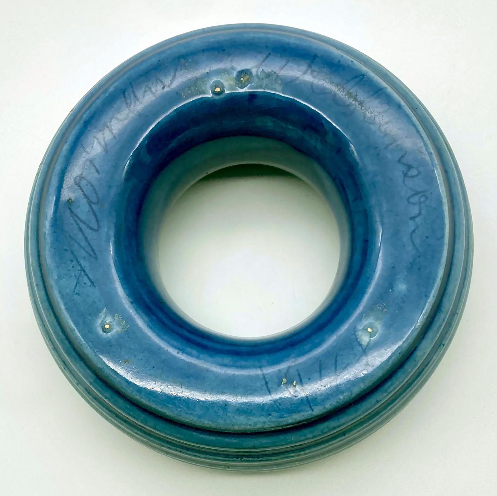 Base view of pottery ashtray showing signature and date