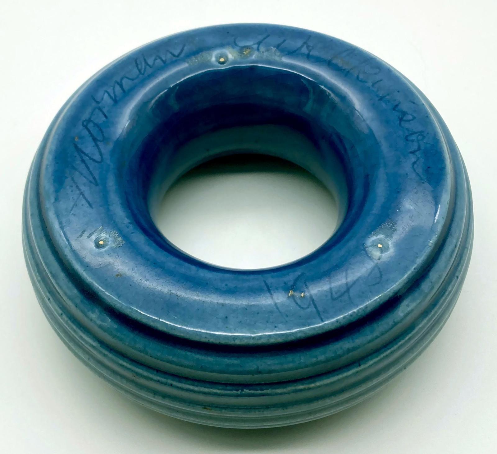 Side view of base of pottery ashtray showing signature and date