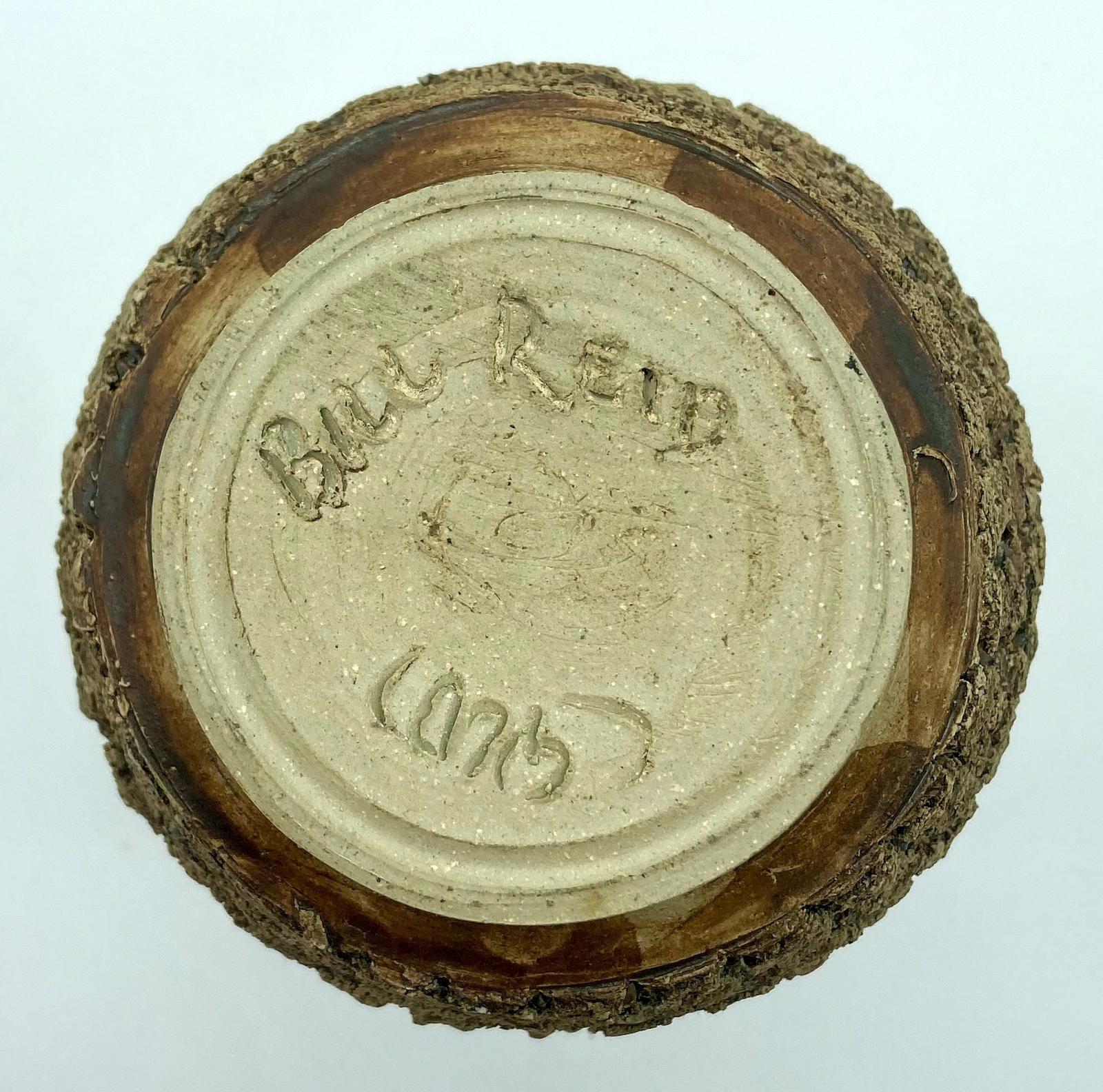 Base view of bark pottery vase made by blinded potter, Bill Reid, showing signature