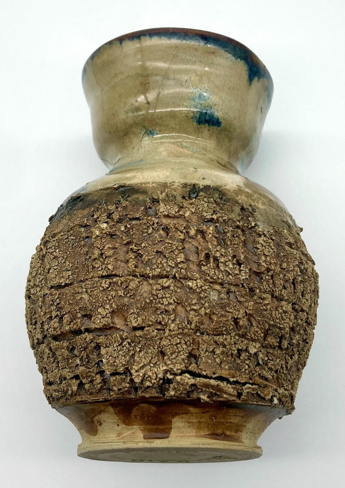 Top view of side of bark pottery vase made by blinded potter, Bill Reid