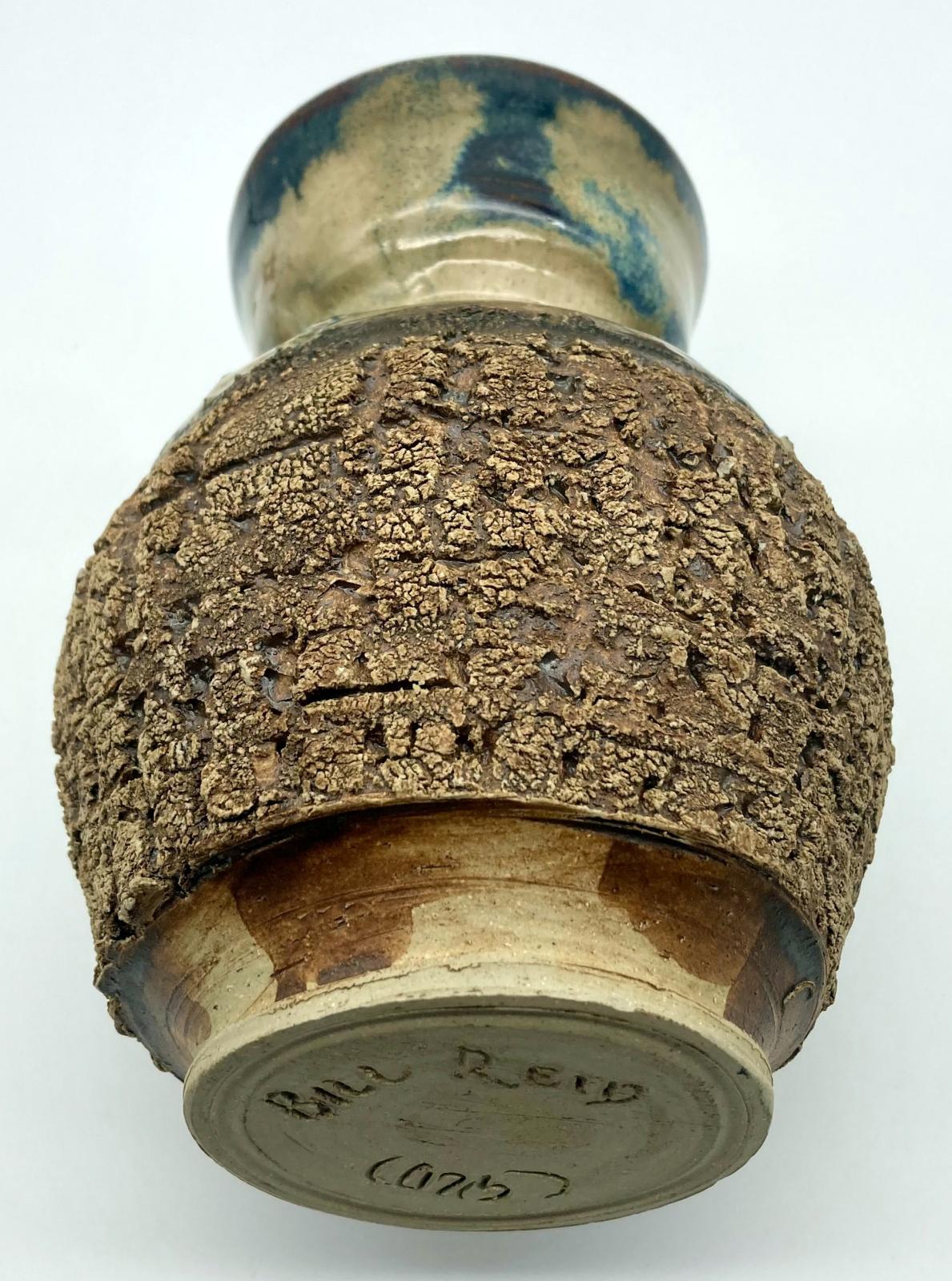Base view of side of bark pottery vase made by blinded potter, Bill Reid
