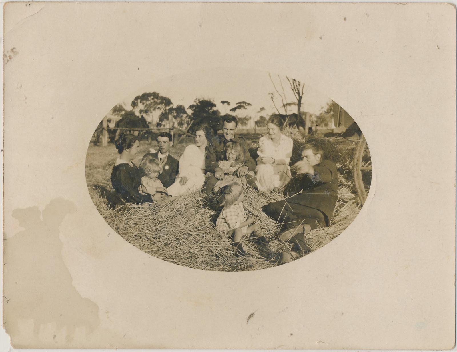 Family sitting in Hay at Charlie Wanke's Farm