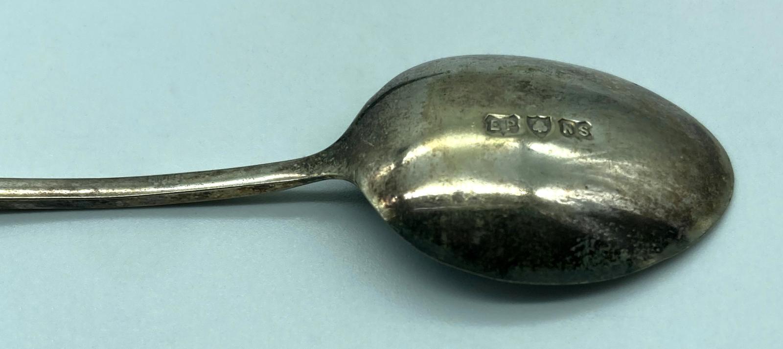 Close up of back of spoon showing markings