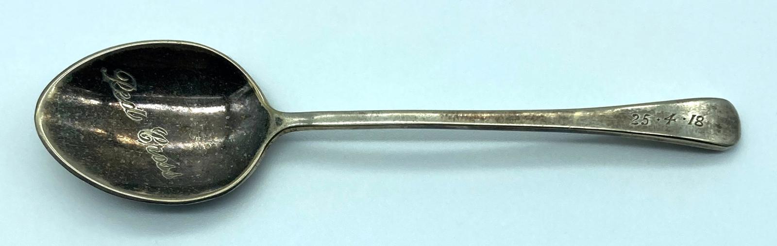 Close up of front of spoon showing engraving