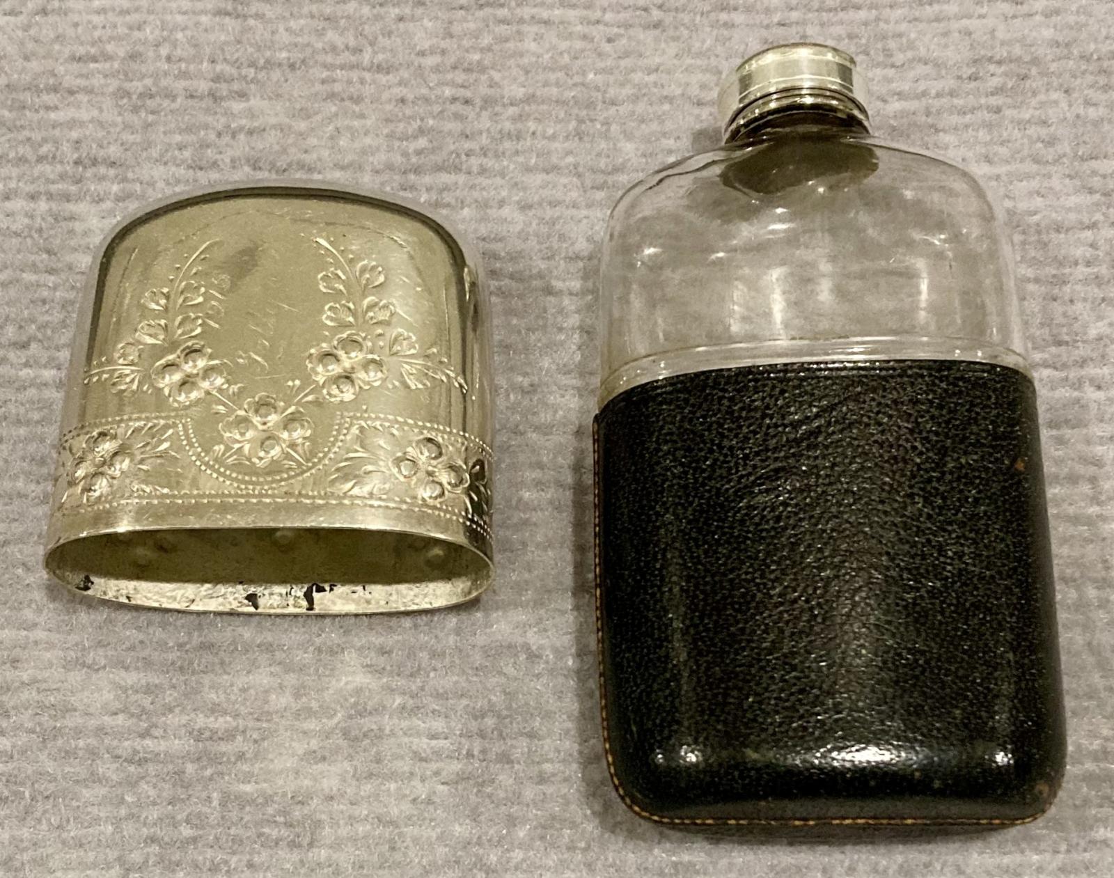 Hip flask with lid off showing bottle