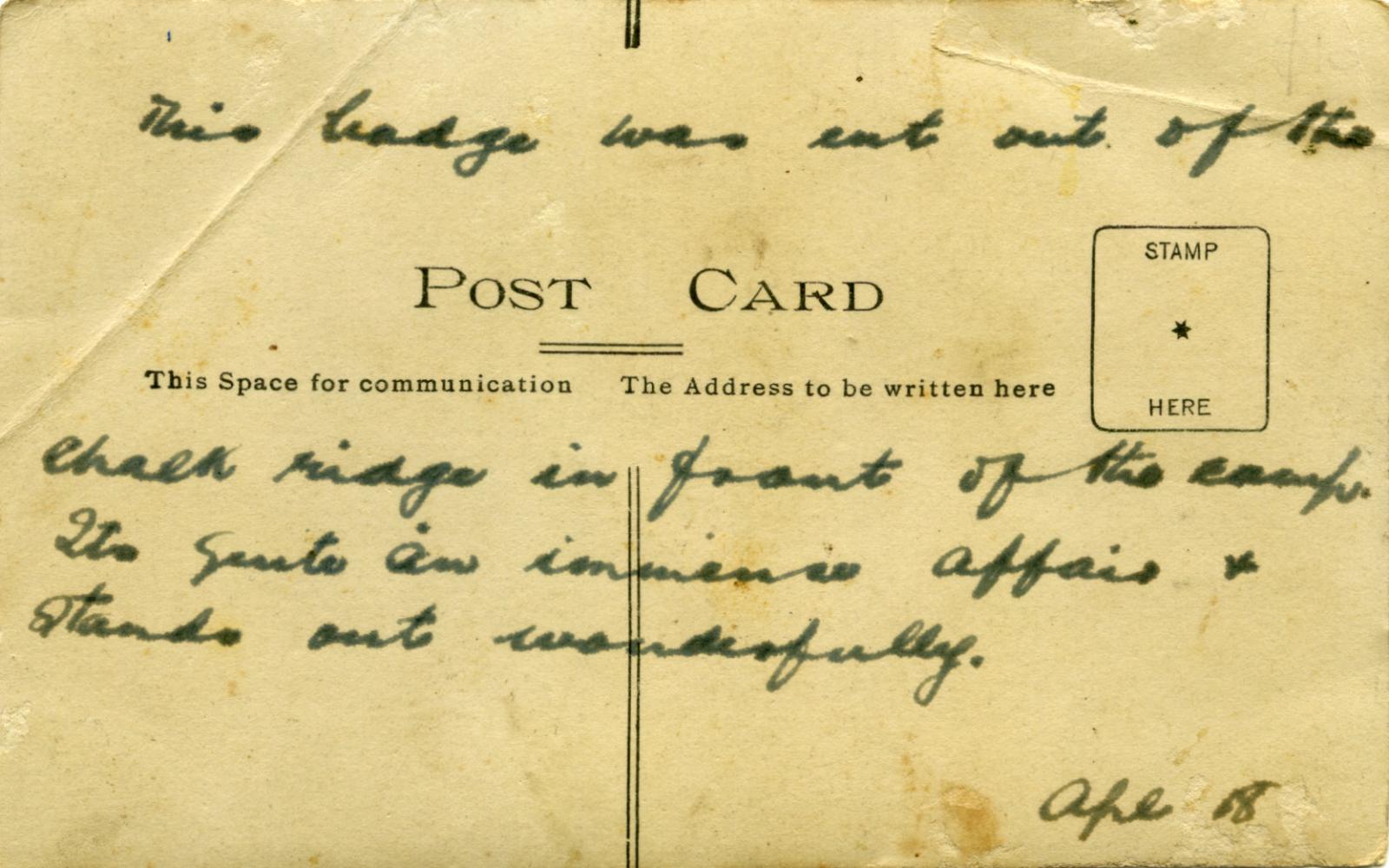 Reverse of RPPC of Australian Rising Sun badge carved into chalk hills in Wiltshire