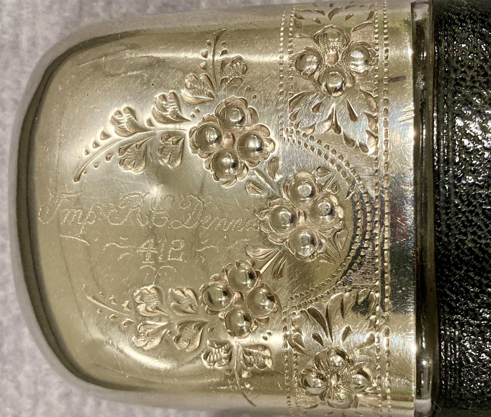 Close up of engraving on lid 'R.C. Dennis 412'