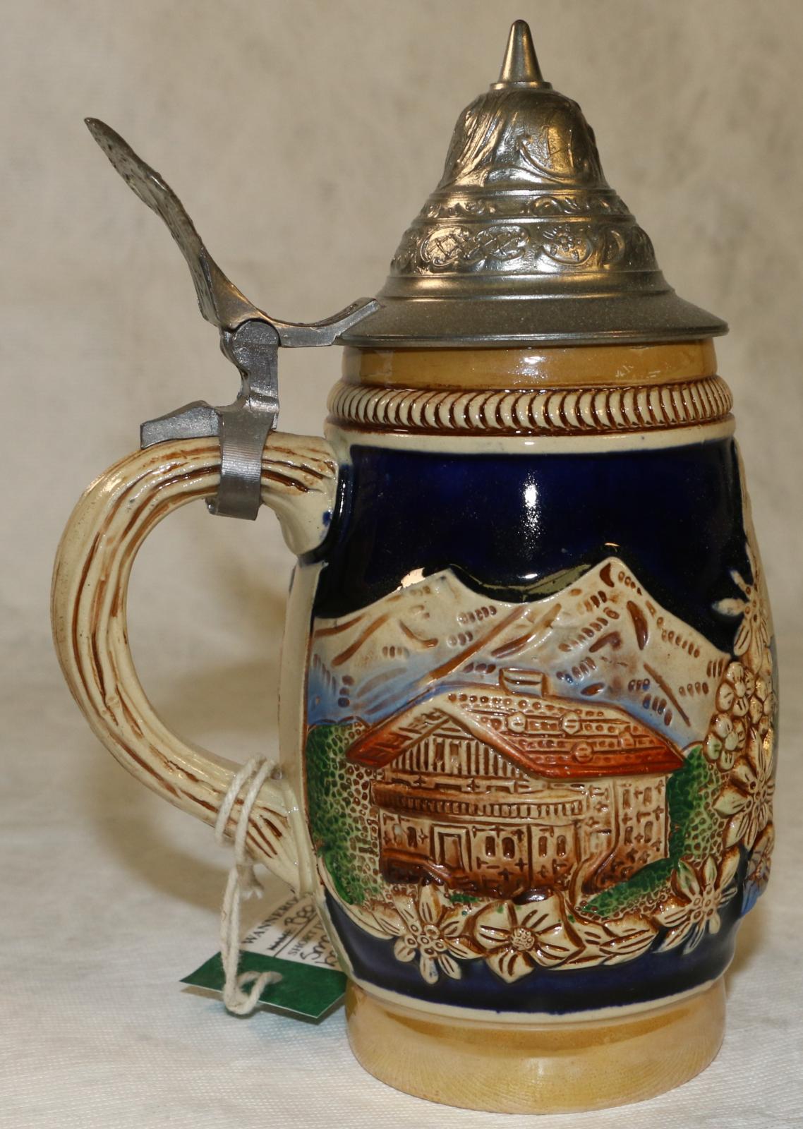 Beer stein, German tourist tankard style, with raised landscape scenes of house, mountains, village, hand painted.