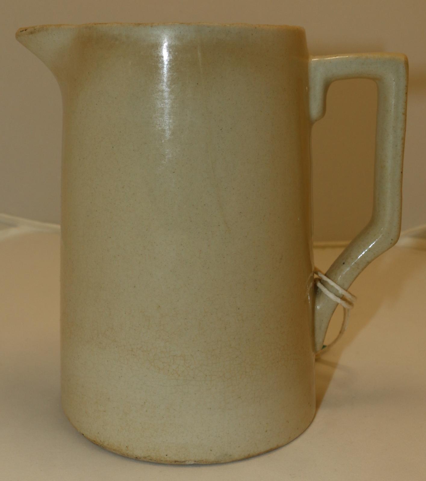 Cream glazed ceramic jug with handle.