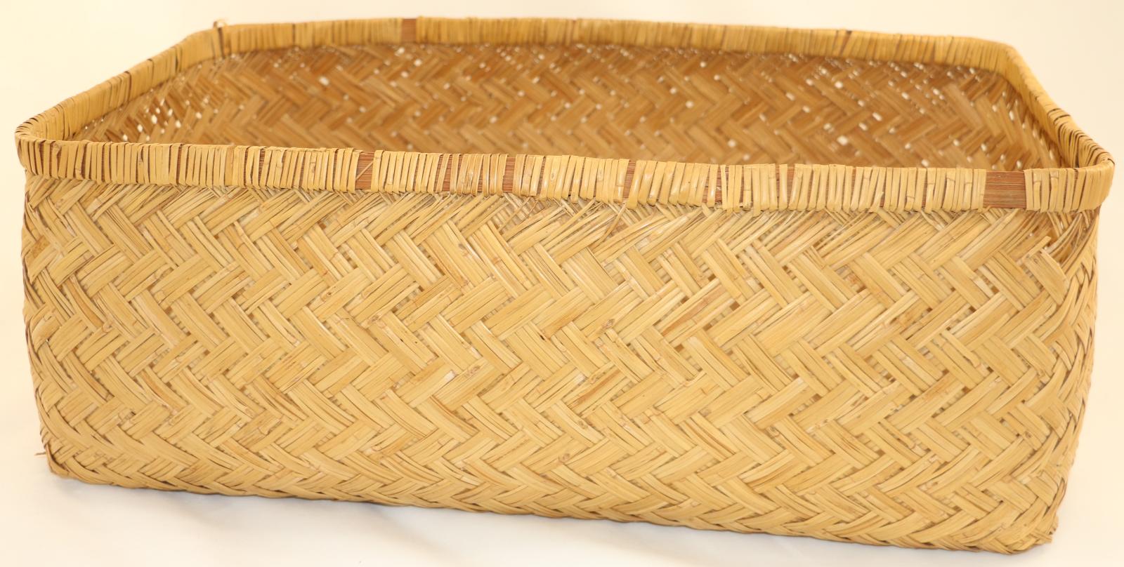 Split cane square basket with crisscross pattern on the sides and base and reinforcement around the top edge which is bound in cane.