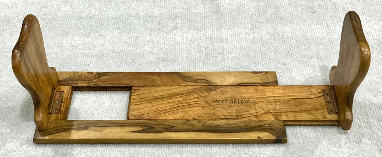 Side view of souvenir olive wood adjustable book shelf with part expansion