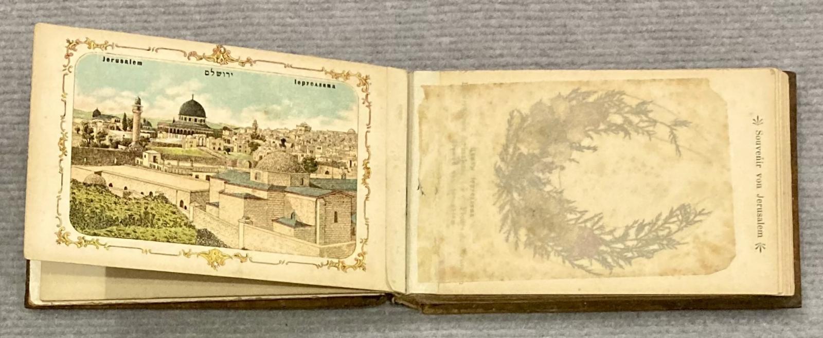 Inside page of souvenir olive wood album showing scene
