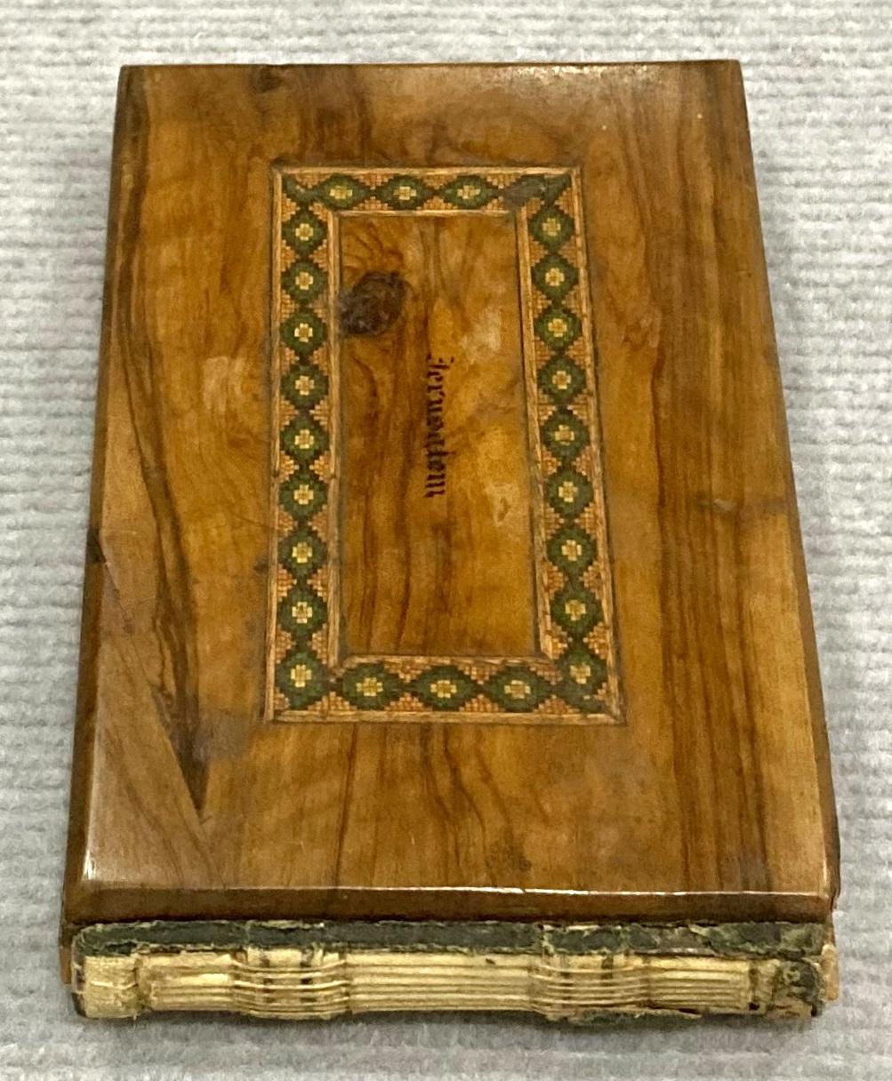 End view of front of souvenir olive wood album 