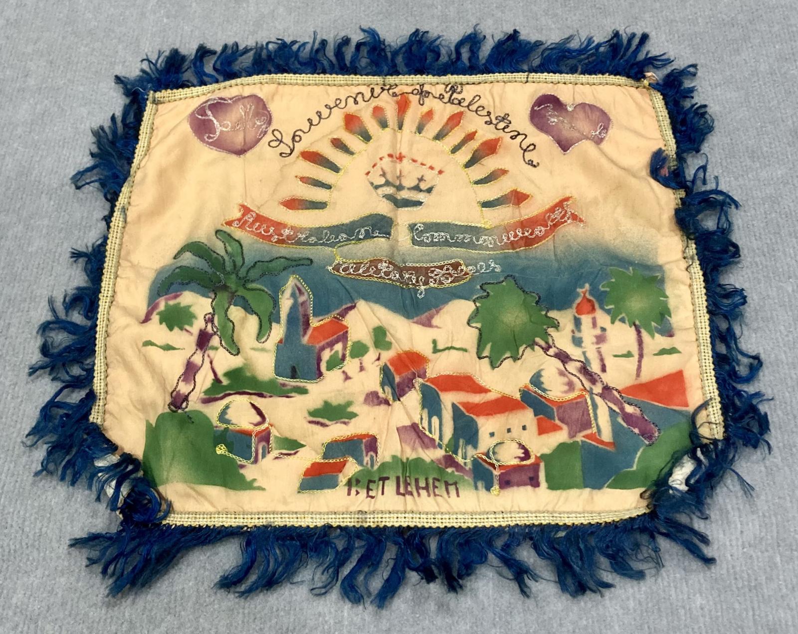 Angled view of souvenir embroidered cushion cover from Bethlehem