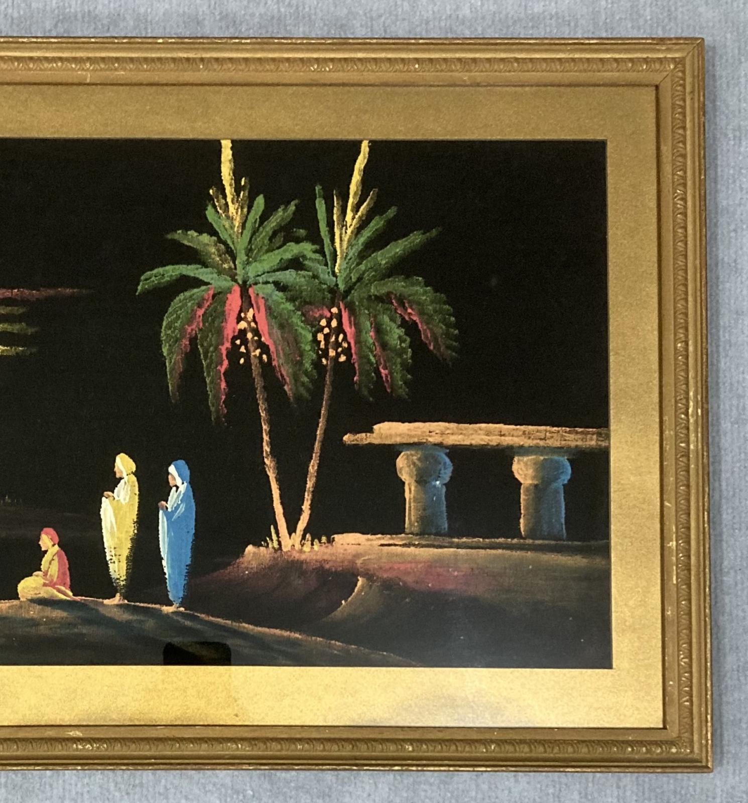 Close up of right hand side of framed painting on black velvet of Middle Eastern scene